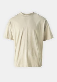 Beige katoenen t-shirt met korte mouwen, een ronde hals en een ontspannen pasvorm. Gladde textuur zonder zichtbare patronen of accenten.