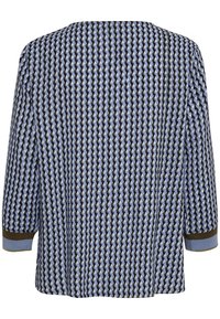 Långärmad skjorta med blå, svart och beige geometrisk mönster, med blå och bruna randiga ärmslut.