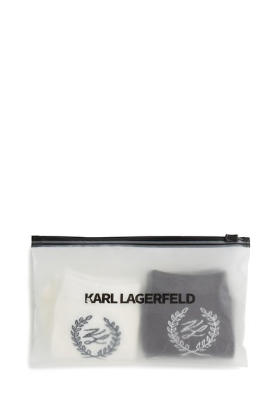 Deux paires de chaussettes Karl Lagerfeld, une blanche et une noire, pliées à l'intérieur d'une pochette plastique translucide zippée avec un marquage noir.