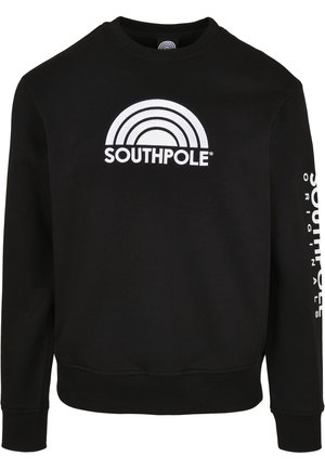 Czarna bluza z długim rękawem z białym logo Southpole i wzorem łuku na przodzie oraz białym pionowym napisem Southpole Originals na prawym rękawie.