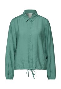 Blouse vert clair à manches longues avec un col et un ourlet à cordon. Fabriquée en tissu lisse avec un léger éclat.
