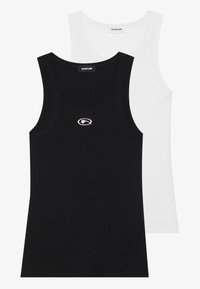 Two ribbed tank tops in black and white. Each features a round neckline and a small embroidered logo on the front. Smooth texture.