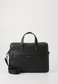 Black leather briefcase with textured finish, dual top handles, adjustable shoulder strap, and a horizontal zip pocket on the front.