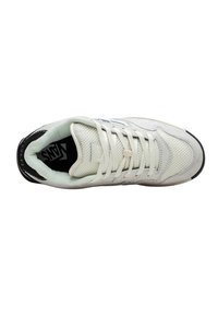 White sneaker with mesh and leather materials, flat laces, black accents, and textured sole. Features a logo on the tongue for branding.