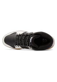 High-top sneaker in black and white leather with a textured black tongue, patterned laces, and rubber gum sole. Features logo on the side.