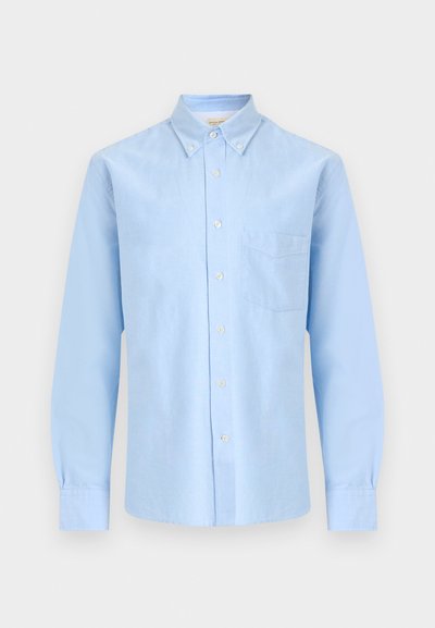 Hellblaues, langärmeliges Hemd mit Knöpfen, Knopfleiste am Kragen und einer einzelnen Brusttasche vor weißem Hintergrund.