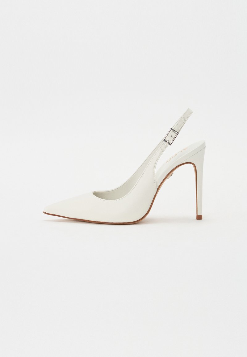 White pointed-toe slingback pump made of smooth leather, featuring a slim, high heel and adjustable buckle strap. Open back design.