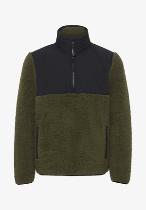 Polarowa bluza w oliwkowym kolorze z czarnym nylonowym panelem na klatce piersiowej. Posiada wysoki kołnierz, zamek błyskawiczny do połowy oraz boczne kieszenie.