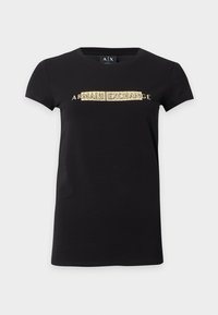 T-shirt noir à manches courtes avec texte doré "ARMANI EXCHANGE" centré sur la poitrine et col rond.