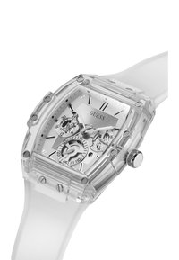 Orologio trasparente con cassa quadrata. Presenta un cinturino in silicone bianco, un quadrante argentato e più piccoli quadranti per le funzioni di cronometro.