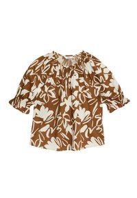 Blouse marron à motif floral avec des dessins abstraits de fleurs blanches, col smocké et manches courtes bouffantes. Fabriquée en tissu léger.