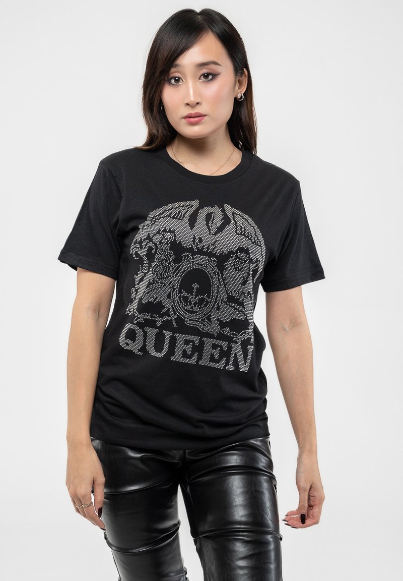 Black t-shirt featuring a graphic design of a crest with "QUEEN" in silver rhinestones. Short sleeves, made of soft cotton material.