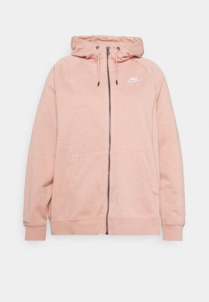 Jasnoróżowa bluza Nike rozpinana na zamek z przednimi kieszeniami, kapturem ze sznurkiem i białym logo Nike na lewej piersi.