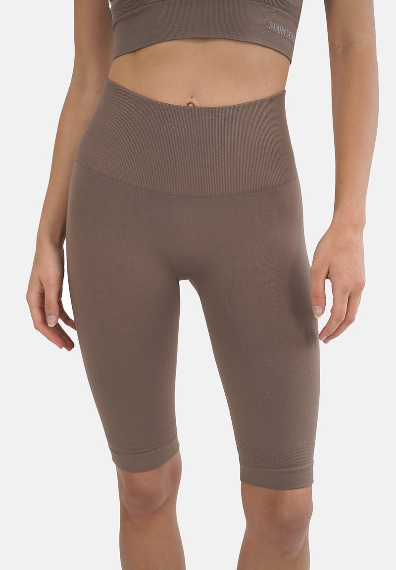 Shorts da bici a vita alta in marrone, realizzati in tessuto elasticizzato a coste. Presentano una finitura liscia e una lunghezza fino a metà coscia con un leggero branding.