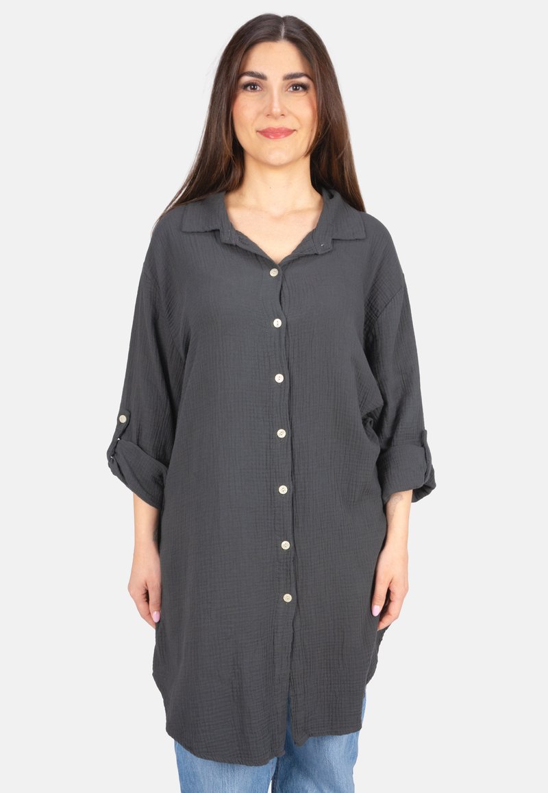 Loose-fitting, dark gray shirt made of textured fabric with a collar, button-down front, and rolled-up sleeves. Features small buttons.