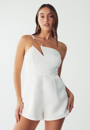 White romper with asymmetrical neckline and keyhole detail. Features a chain accent on one strap. Smooth fabric and tailored fit.