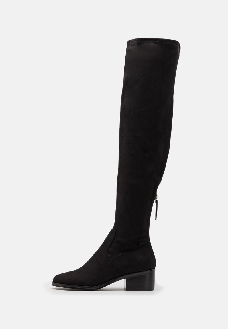Tall black suede boot with low block heel and side zipper, displayed on a white background, side view.