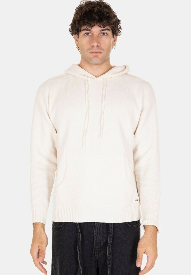 Felpa color crema realizzata in un tessuto a coste, con tasca frontale, cappuccio con cordino e polsini e fondo a coste.