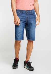 Denim shorts in medium blue, featuring a straight cut and knee-length design, with classic five-pocket styling and visible stitching details.