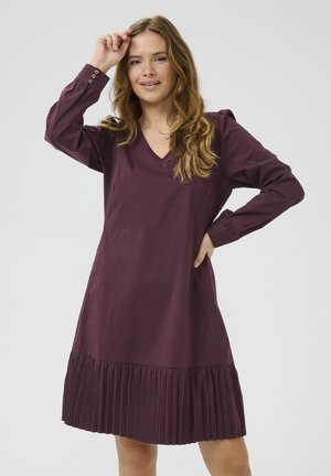 V-neck, long-sleeve, plum-colored dress with pleated hem and buttoned cuffs. Made of smooth fabric, features a relaxed fit and side pockets.