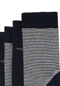 Marinblå och vita randiga strumpor i bomull med ribbade muddar och logodetalj. Har en slät textur och klassisk design.