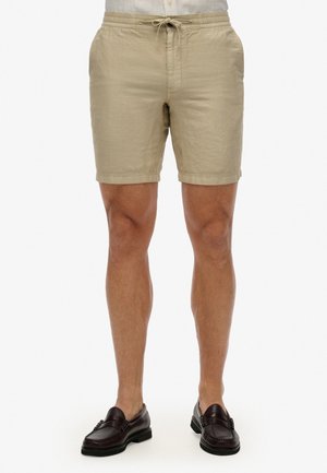Pantalones cortos de lino beige con waistband elástico y cordón, con bolsillos laterales y un ajuste holgado, de longitud por encima de la rodilla.