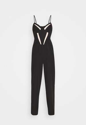 Zwarte mouwloze jumpsuit met dunne bandjes en witte mesh delen op de borst en taille, ontworpen voor een slanke pasvorm.