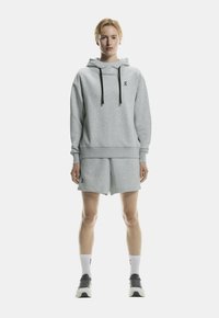 Gray sweatshirt with a hood and black drawstrings, paired with matching shorts. Features a logo on the chest and shorts. Plain texture.