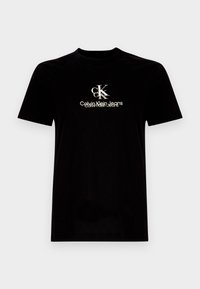 Černé bavlněné tričko s kulatým výstřihem, na přední straně s bílým a zlatým logem "CK" a textem "Calvin Klein Jeans".