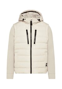 Puffer jacket in light beige with a quilted pattern, ribbed beige sleeves, black zipper, adjustable hood, and side pockets.