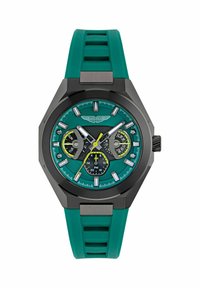 Reloj Aston Martin con caja negra octagonal, correa de goma teal, esfera teal vibrante, marcadores de hora plateados y tres subesferas con acentos amarillos.