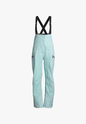 Mint green waterproof overalls with adjustable X-back straps, zippered pockets, and a smooth, matte texture. Designed for outdoor activity.