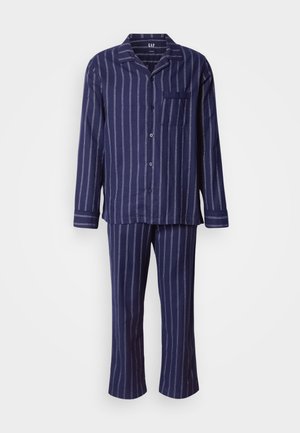 Marinblå pyjamaset med vita vertikala ränder, inklusive en knäppbar topp med en ficka och långbyxor, tillverkad av mjukt tyg.