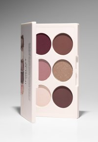 Eyeshadow palette featuring six circular shades: deep plum, soft pink, matte taupe, shimmering beige, and dark berry in a white case.