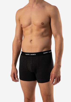 Zwarte katoenen boxershorts met een zachte tailleband met het label "HAPPY SHORTS." De stof heeft een gladde textuur en een aansluitend ontwerp.