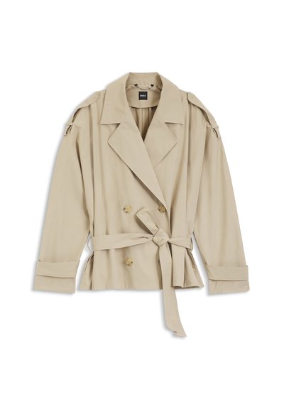 Trench-coat beige à double boutonnage avec larges revers, taille ceinturée, poignets boutonnés et épaulettes, posé à plat sur fond blanc.