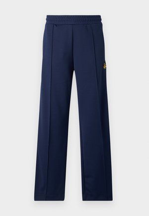 Granatowe spodnie sportowe o gładkiej fakturze, elastycznym pasie i małym haftowanym logo na górnej lewej nodze. Klasyczny krój prosty.