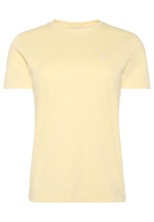 Tričko s krátkým rukávem a kulatým výstřihem v bledě žluté barvě s malým bílým logem "ck" na levé straně hrudi.