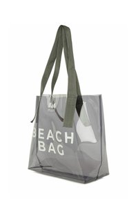 Priehľadná PVC plážová taška so sivou farbou, zelenými textilnými popruhmi a bielym nápisom "BEACH BAG". Má štruktúrovaný, otvorený dizajn.