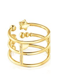 Gold-toned metal cuff bracelet featuring a geometric open design with circular and leaf-shaped accents. Smooth texture with polished finish.