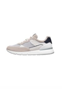 Zapatillas deportivas beige y gris con materiales de malla y gamuza, una suela blanca acolchada y acentos azul marino oscuro en el talón y la lengüeta.