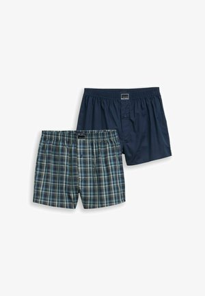 Due paia di boxer da uomo, uno blu navy tinta unita e uno a quadri blu-verdi, entrambi con fascia elastica in vita e bottoni frontali.