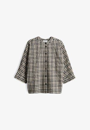 Gestepptes Hemd in Beige mit schwarzem Karomuster, rundem Halsausschnitt und Dreiviertelärmeln. Verfügt über schwarze Knöpfe auf der Vorderseite.
