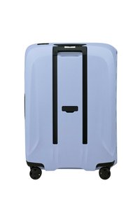 Hard-shell suitcase in light blue, with black accents. Features two black wheels, suitcase handle, and a textured surface with vertical lines.