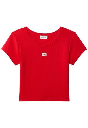 Piros, rövid ujjú, rövidített póló, kerek nyakkivágással és kis fehér Calvin Klein logóval a mellkas közepén.