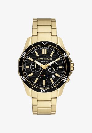 Kuldne roostevaba terasest kell musta tekstureeritud sihiga, kronograafi funktsioonide ja suurte tunni markeritega. Veekindel kuni 100 meetrit.