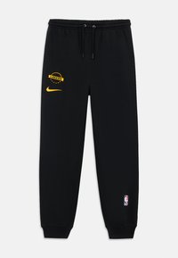 Sorte joggebukser laget av myk stoff, med et gult "Lakers"-logo og en Nike Swoosh. Elastisk midje og mansjetter. NBA-logo på benet.