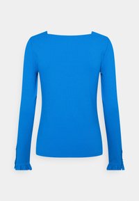 Långärmad topp i klarblått, med fyrkantig halsringning och rynkade ärmslut med knapppryttningar. Tillverkad av ett glatt tyg.