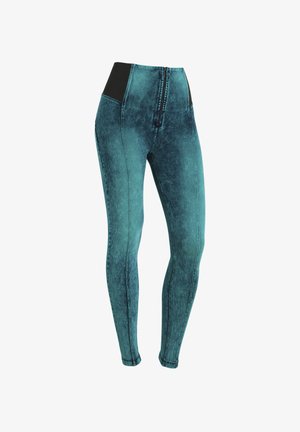 Leggings a gamba affusolata in un denim teal scolorito, con un ampio elastico nero in vita e una zip frontale. Tessuto liscio con cuciture ben visibili.