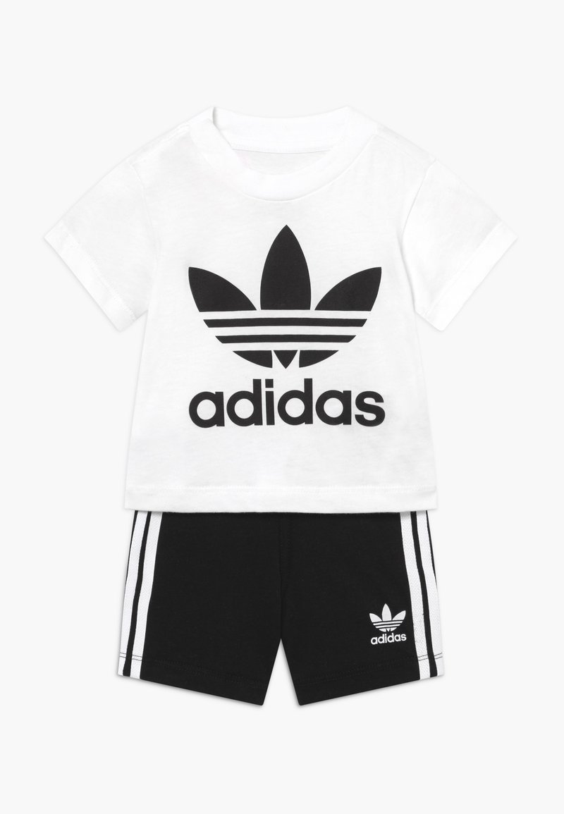 White cotton t-shirt with black Adidas logo and flower design, paired with black shorts featuring white side stripes and logo.